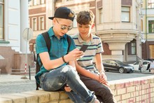 The Friendship And Communication Of Two Teenage Boys Is 13, 14 Years Old, City Street Background
