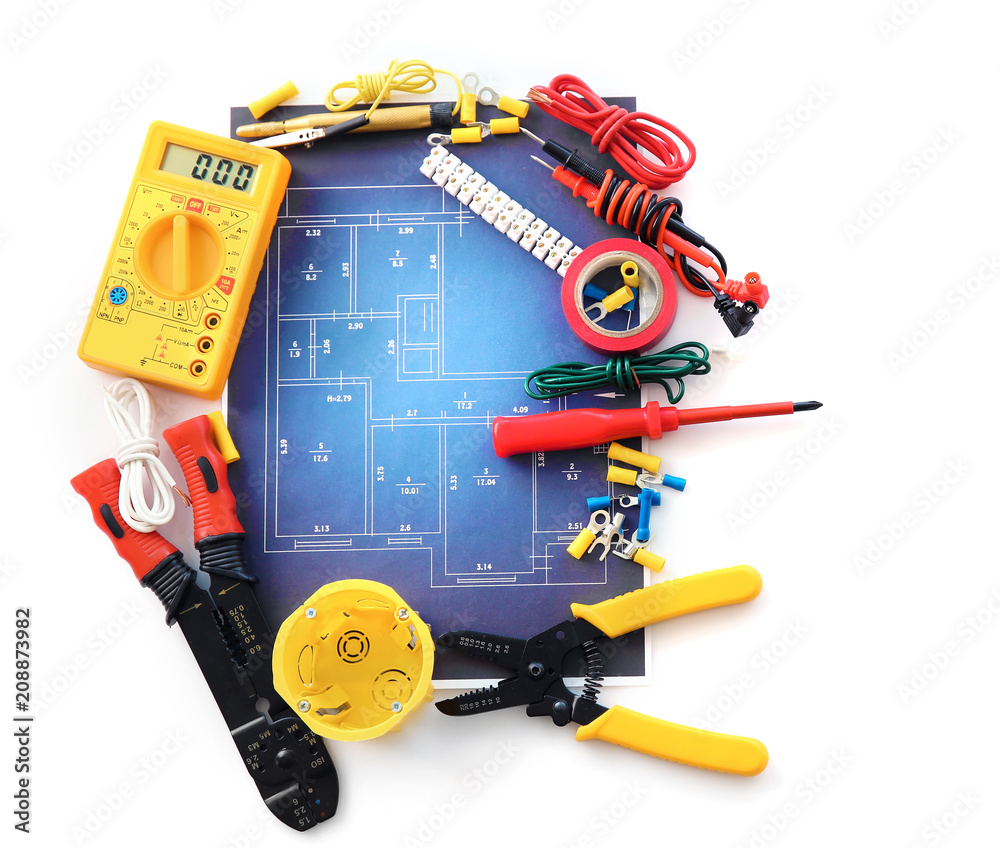 Electrician's supplies with electrical scheme on white background