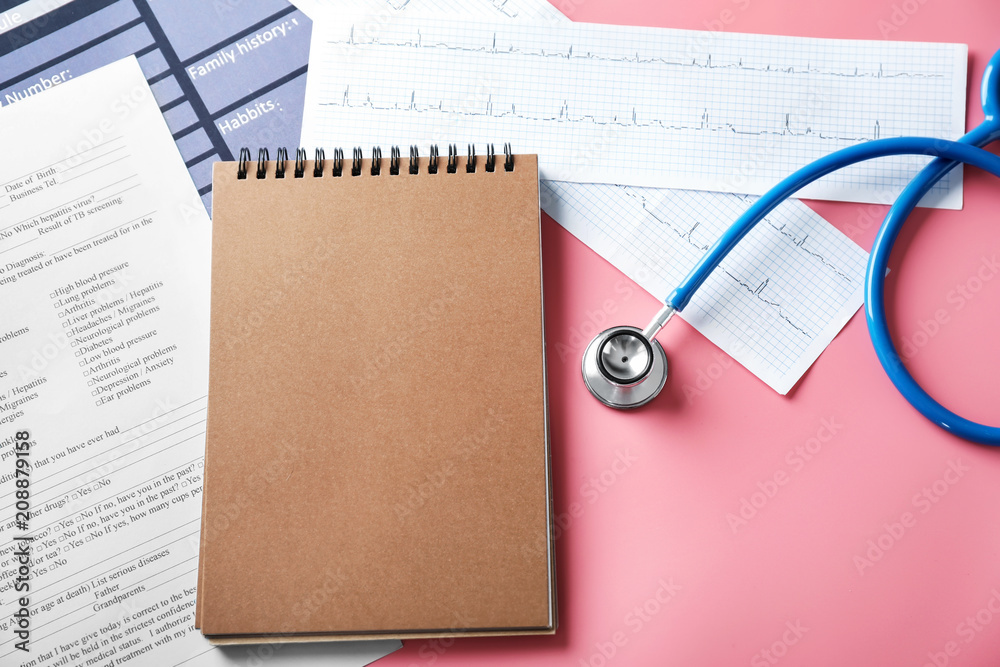 Composition with stethoscope and notebook on color background. Health care concept