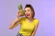 © Pixel-Shot - Emotional young woman with pineapple on color background