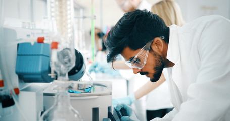 male student of chemistry working in laboratory