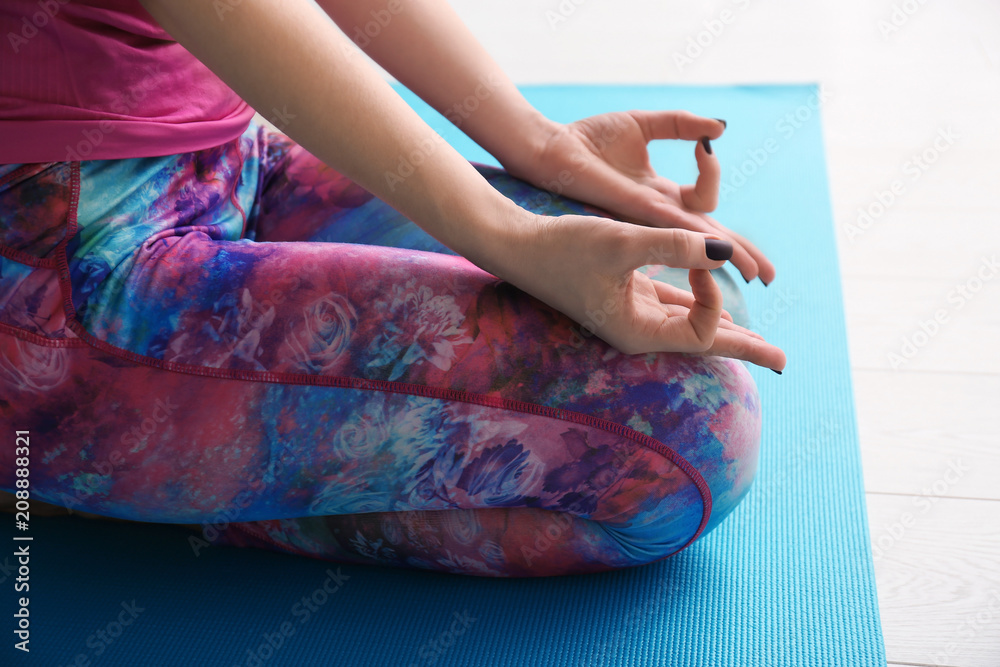Young woman practicing yoga indoors, closeup
