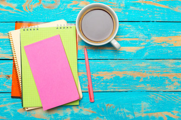 Wall Mural - Cup of coffee with notebook on wooden desk