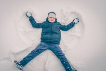 Boy In The Snow Makes A Snow Angel, Winter Snow Frosty Weather