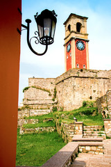 Wall Mural - beautiful landscape with a clock and bell tower in the old fortress in kerkira, corfu, greece. popul