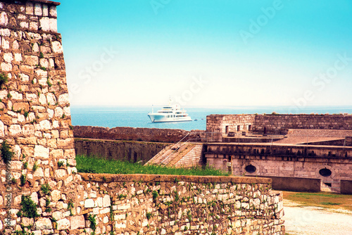 Captivating charming view of the ship in the harbor near the old fortress in ...