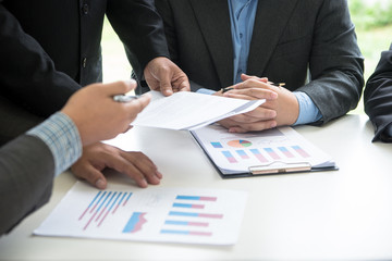 Business Team partners reading a document before signing contract agreement was signed co-investment business.business managers team working with new startup project in office room. Selective focus.