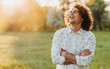 © iuricazac - Handsome happy young male smiling with curly hair posing in the city park looking at the sky, cross his hands and dreaming. Copy space for your advertising. People, lifestyle and emotion concept