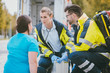 © Kzenon - Emergency medics talking to injured woman in front of ambulance