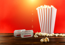 Red And White Bucket Of Popcorn With Two Red Movie Ticket