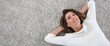 © goodluz - Upper view of woman relaxing on carpet at home, template