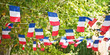 Blue white red french flags garland decorating a village square, July 14 party panoramic web banner