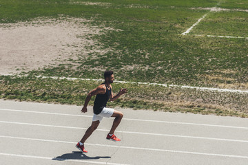 Wall Mural - high angle view of male sprinter on running track at sport playground