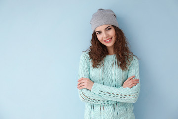 Portrait of beautiful young woman in casual clothes on color background