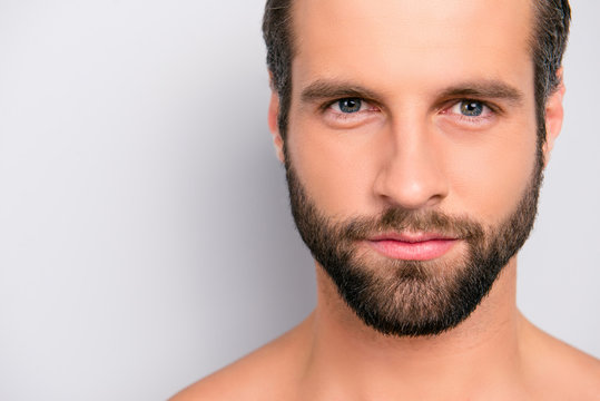 Close up cropped portrait with copy space of virile, harsh, manly, attractive, naked, unshaven, handsome, stunning man with ideal, perfect face skin, looking at camera, isolated on gray background