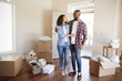© Monkey Business - Happy Couple Surrounded By Boxes In New Home On Moving Day