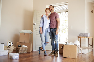 Wall Mural - Happy Couple Surrounded By Boxes In New Home On Moving Day