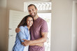 © Monkey Business - Portrait Of Couple By Open Front Door In Lounge Of New Home