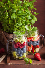 Wall Mural - fruit salad in mason jar strawberry blueberry kiwi apple mint