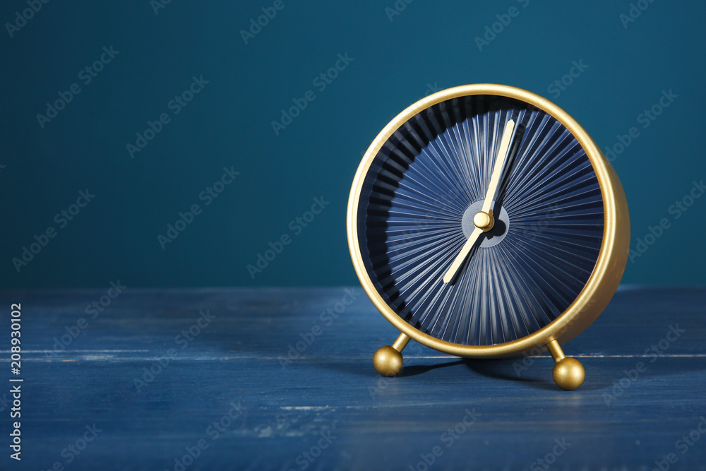 Alarm clock on table against color background. Time management concept