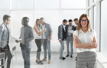 Wall Mural - business woman and a group of employees standing in the office