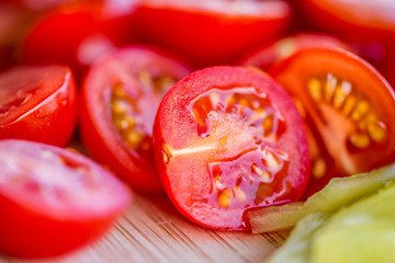 Tomatoes macro, red healthy vegetable sliced on wooden desk. Macro detail of red fresh tomato from garden.