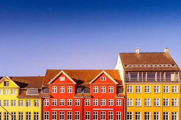 Wall Mural - beautiful colorful historical houses against blue sky in copenhagen, denmark