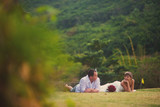 Fototapeta Kuchnia - the bride and groom lie on the grass