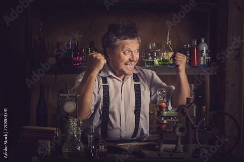 Láminas medieval scientist reading book in his laboratory