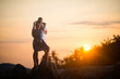 © Vladimir - Young couple embracing at sunset in the rocks in the tropics