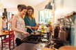 © jackfrog - Mixed group of friends have fun while cooking a meal in kitchen