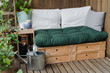 Cozy wooden pallet couch on balcony