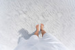 Young woman looking down pov point of view perspective on bare feet standing in white sand in Fort Walton Beach, Florida, in white dress, flat top view with shadow