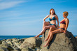 © Anton Gvozdikov - Two young women posing on the stony beach