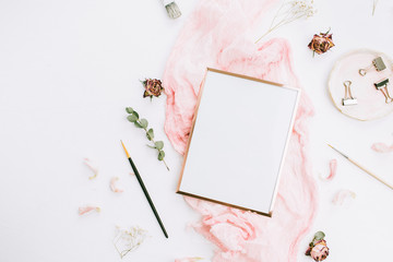 Wall Mural - Photo frame with copy space on pink blanket with eucalyptus branches and rose flowers on white background. Flat lay, top view still life artist concept.