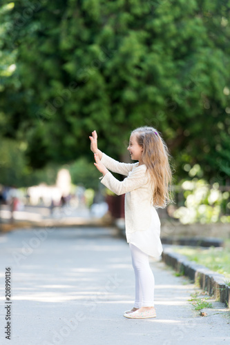 Small Child With Long Hair Play Outdoor Happy Girl In Summer Park