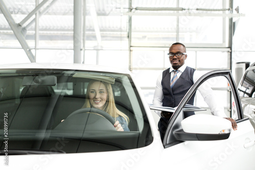 African Man Shows The Girl A New Car Inside The Cabin Buy This