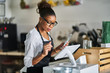 © Joshua Resnick - shop assistant placing order from notepad into pos point of sale terminal at register in restaurant