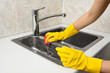 hands cleaning kitchen sink