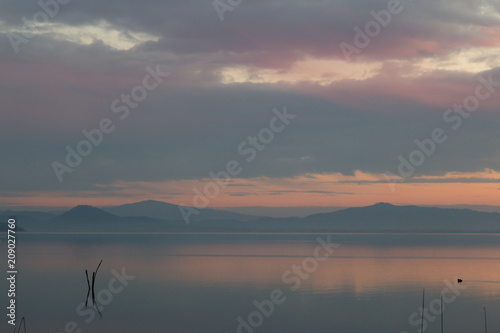Plagát A lake at dusk, with beautiful, warm tones in the sky and water