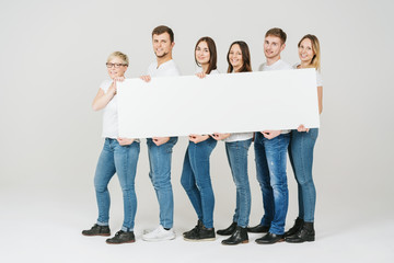 happy confident group of friends holding a banner