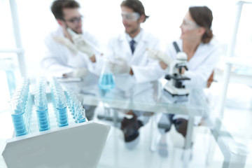 Wall Mural - background image of scientists studying blue liquid in a flask