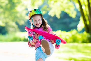 Wall Mural - Child riding skateboard in summer park