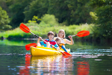 Child on kayak. Kids on canoe. Summer camping.