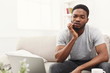 © Prostock-studio - Young african-american man having toothache at home