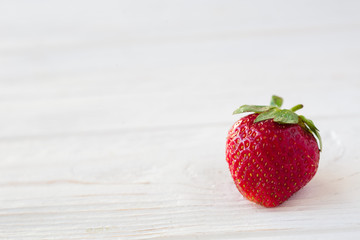 Wall Mural - Strawberries ripe on a white wooden background. Copy space. Healthy lifestyle concept