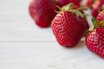 Wall Mural - Strawberries ripe on a white wooden background. Copy space. Healthy lifestyle concept