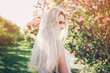 © Мария Кокулина - Woman with  long blond hair in the garden with flowers. Beautiful girl on a sunny day.