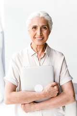 Wall Mural - Happy mature business woman hugging laptop