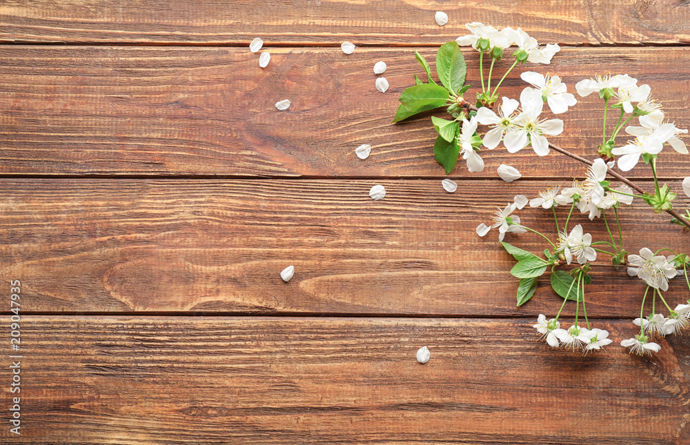 Beautiful blossoming branch on wooden background